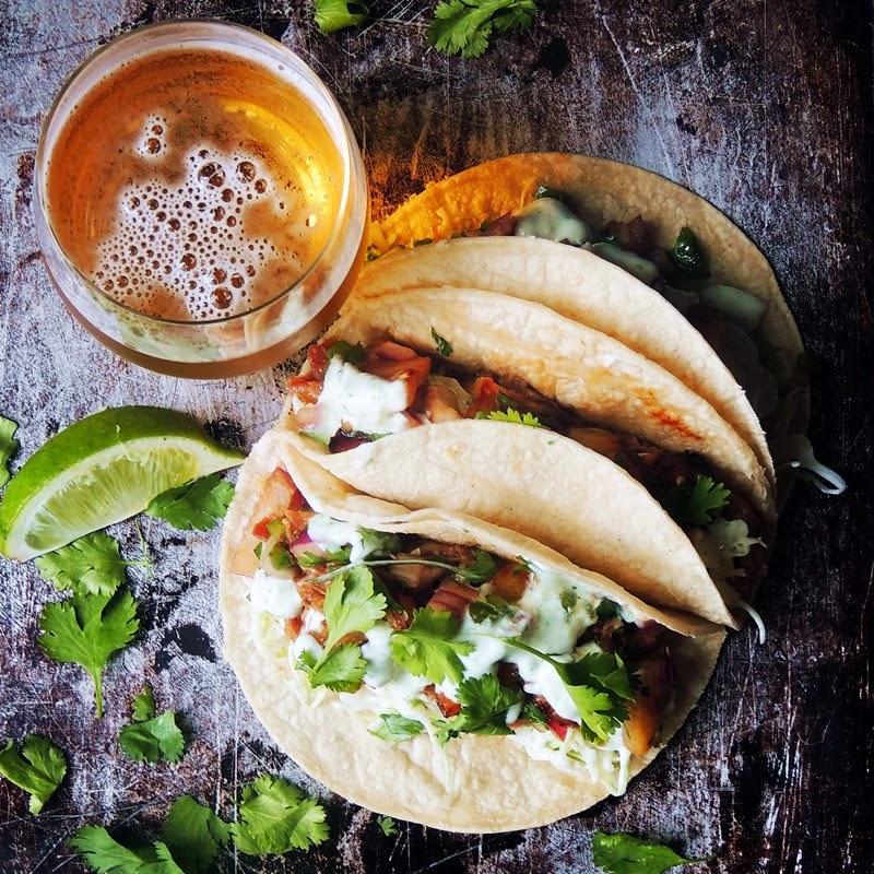 Slow Cooker Kalua Pork Tacos - Tender juicy pork, in a Hawaiian inspired sauce, wrapped in a warm corn tortilla. Your taste buds will say "Hola" to this tasty fusion taco! From www.bobbiskozykitchen.com