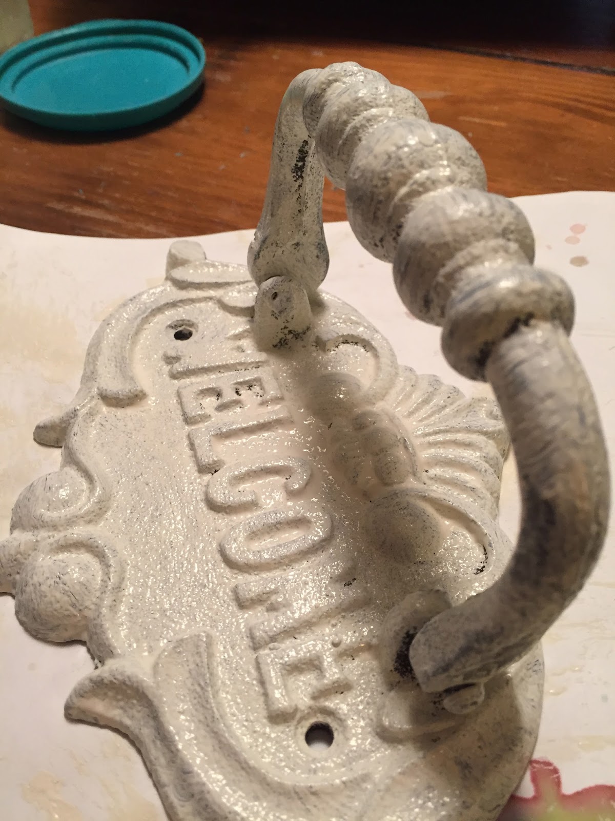 SheShe, The Home Magician Painting a cast iron door knocker.