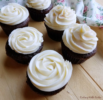 Adding a little "liquid gold" sweetened condensed milk to buttercream makes it feel extra special. It add that little bit of rich depth of flavor you can't get anywhere else! chocolate cupcakes with sweetened condensed milk buttercream piped in rosettes and ruffles