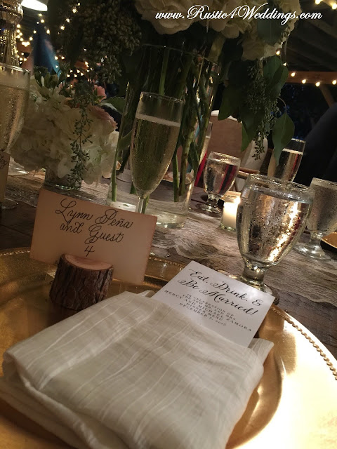 Place Setting at Rustic Beach Wedding Featuring a Rustic Tree Branch Place Card Holder Place Setting at Rustic Beach Wedding Featuring a Rustic Tree Branch Place Card Holder