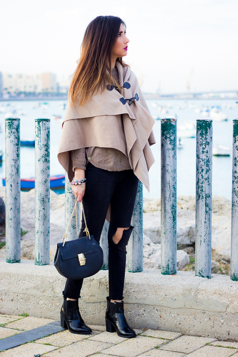ripped jeans and poncho