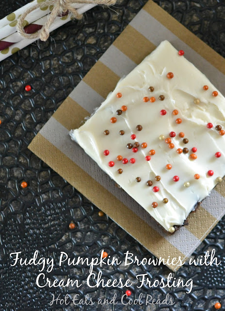 Two ingredient brownies with a layer of delicious homemade frosting on top! So perfect for fall! Fudgy Pumpkin Brownies with Cream Cheese Frosting Recipe from Hot Eats and Cool Reads