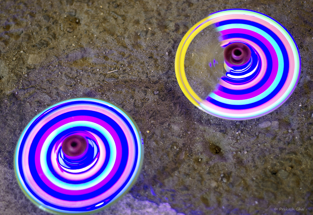 A Minimalist Photo of Spinning tops on the street, used by children to play.