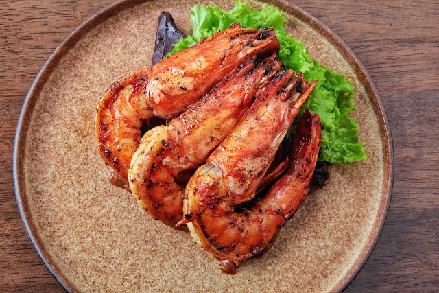 Grilled prawns in tamarind dressing & greens Grilled prawns in tamarind dressing & greens
