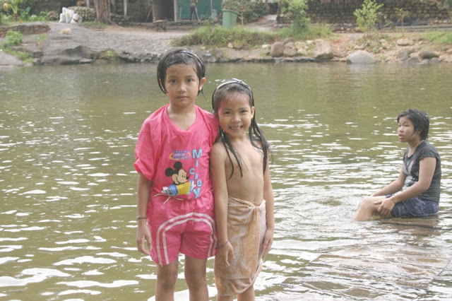 Our hosts little girls swimming in the river by Ban Khiri Wong.