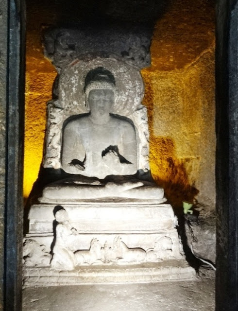 Buddha Idol in the Ajanta cave 11 - there is one devotee at the foot Buddha Idol in the Ajanta cave 11 - there is one devotee at the foot