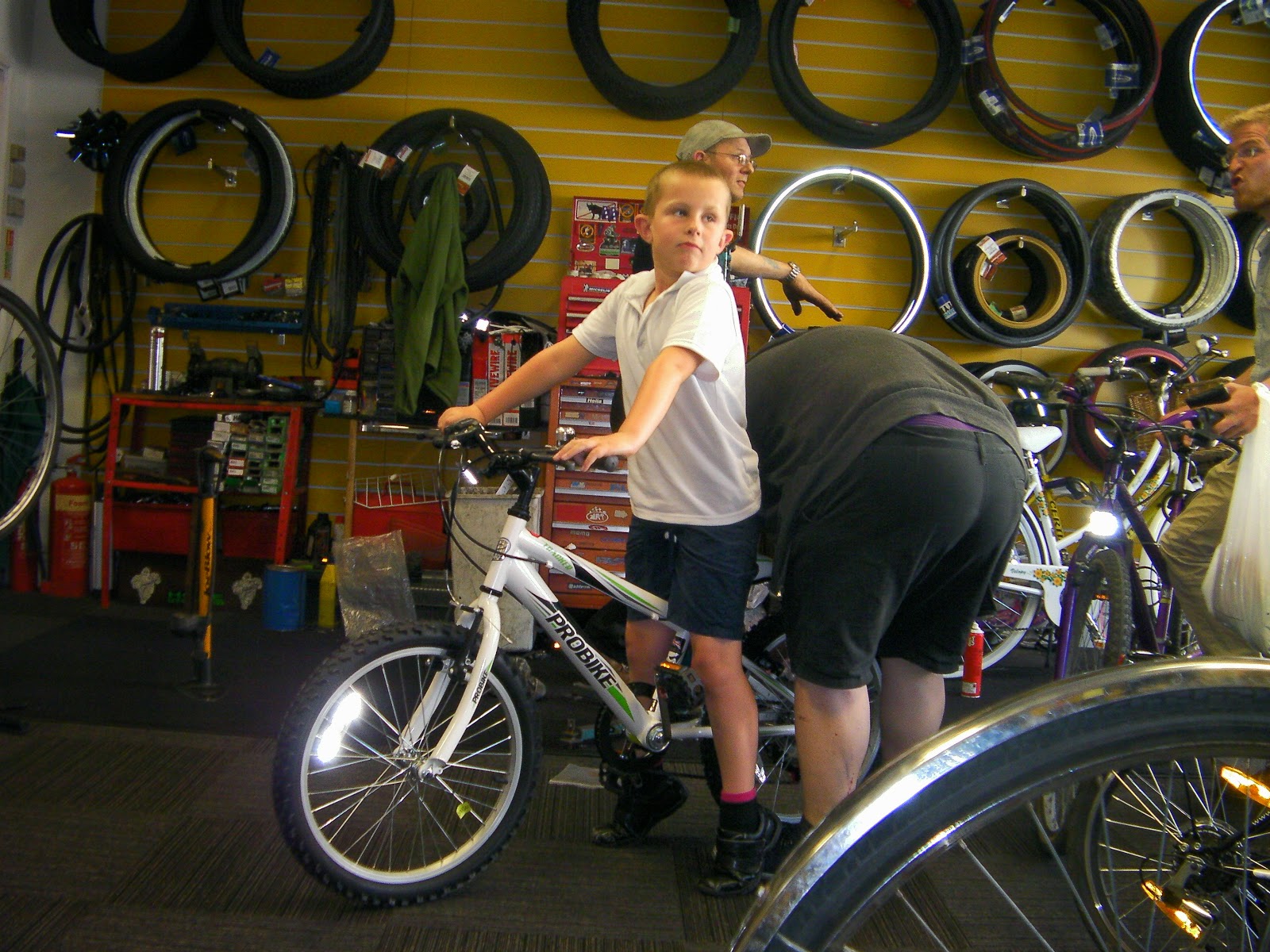 being measured up for a new bike in cycle shop aged 8 portsmouth cycle exchange victoria road north portsmouth