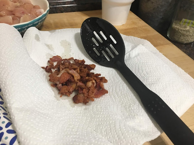 The cooked bacon on a paper towel on the counter. 