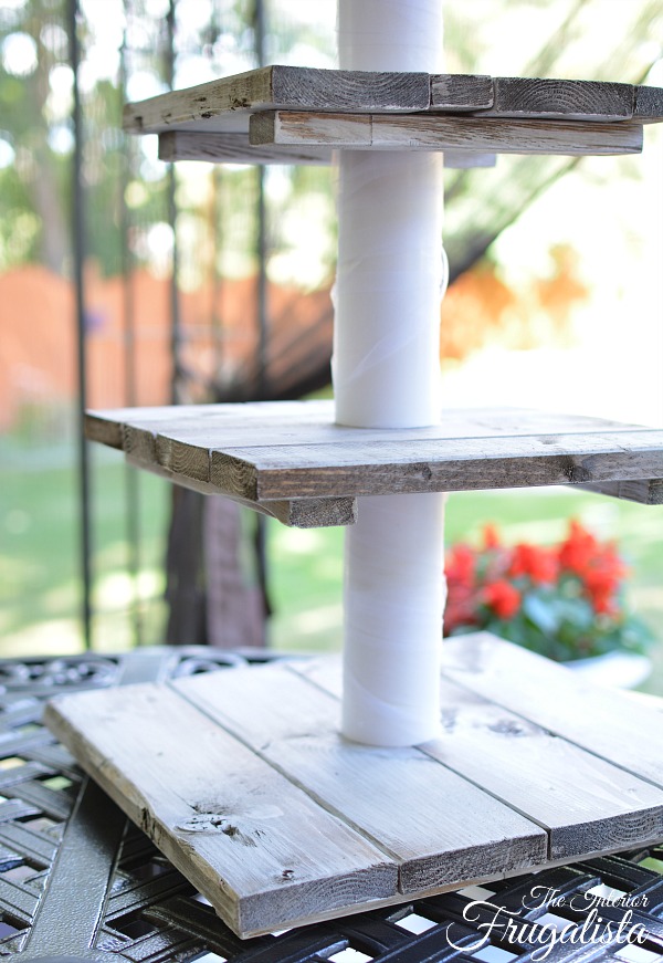 A portable DIY four-tiered rustic country wedding cupcake stand with small top tier for cake topper, easily assembled on site for destination wedding.