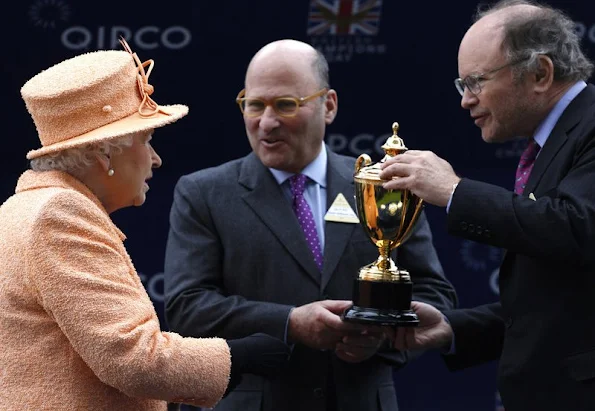 Queen Elizabeth II presents the trophy to owners Alain Wertheimer and Gerard Wertheimer, after their horse Solow won the Queen Elizabeth II Stakes Race