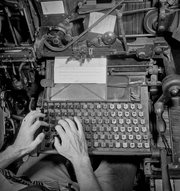 A linotype operator types out a story in the composing room. The linotype is used to cast metal blocks of type which will then be laid out into a page.