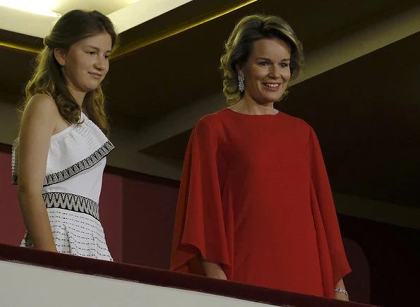 Queen Mathilde wearing a new red dress at a final of the Queen Elisabeth Music Competition. Crown Princess Elisabeth wore a white shoulder open embroidered dress