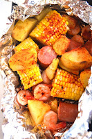 Cajun Shrimp Boil Foil Packets take just 20 minutes to make and are full of cajun flavor with shrimp, sausage, corn and potatoes! They are made on the grill in an aluminum foil packet for a quick meal. www.nutritionistreviews.com