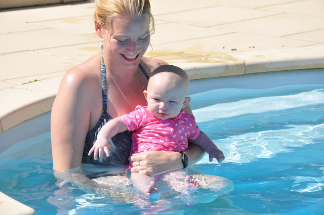 Me in a bikini holding my baby Little in the swimming pool