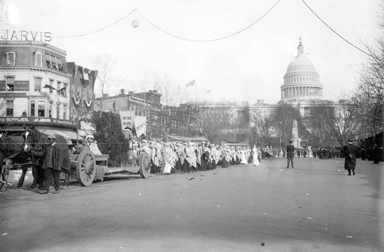 Part of the 1913 Suffrage Parade. The signs read 