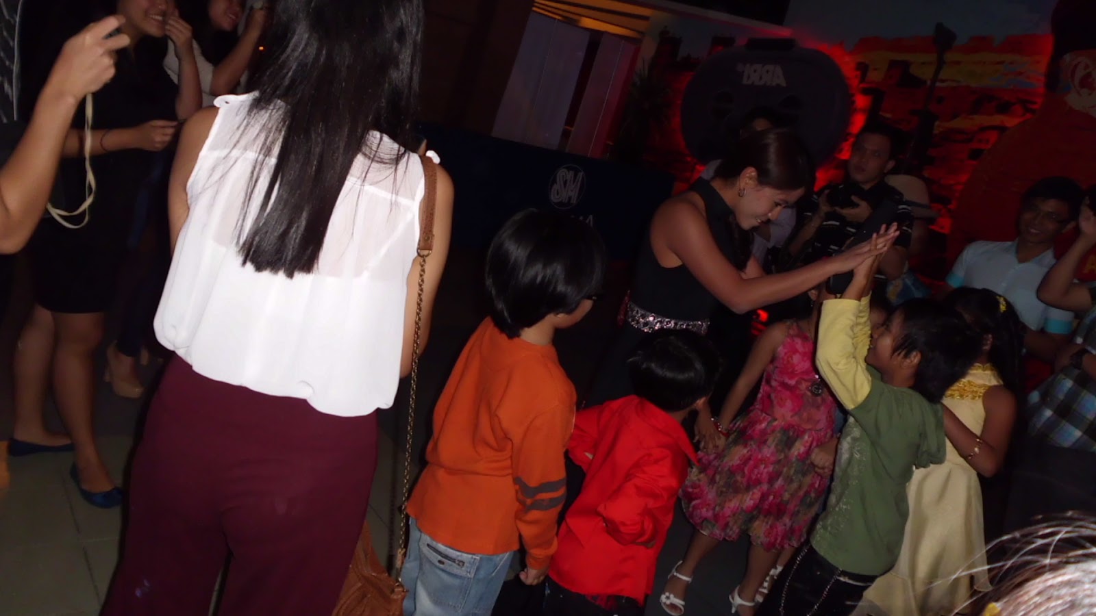 Krizzie and the hyperactive (for lack of a better term) kids of Tahanan: the moment she arrived, they all rushed towards her.