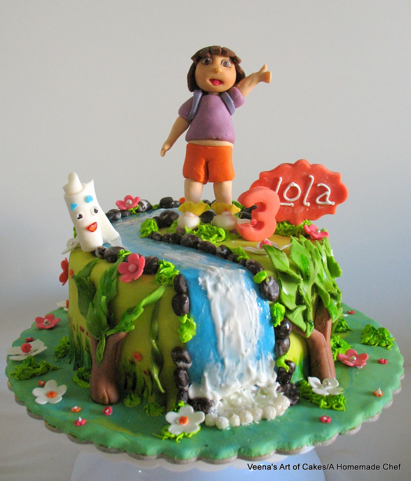 A cake decorated with Dora the explorer theme.