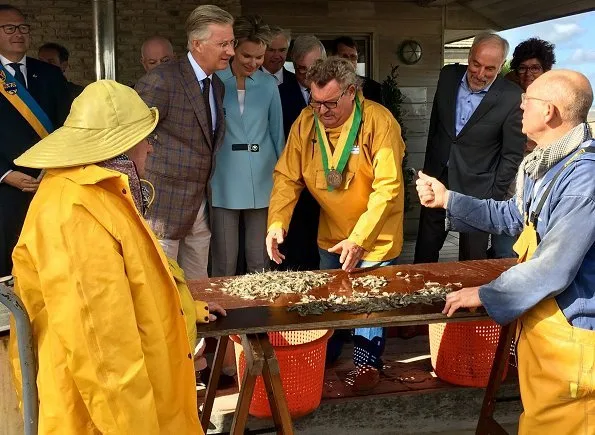 Queen Mathilde and King Philippe visited Orde van de Paardevisser in Oostduinkerke. Queen wore Dries Van Noten coat