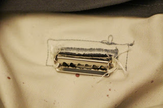 The buckle, stitched in place