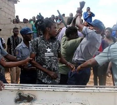 Photos: Man almost lynched by angry mob after he stabbed another man to death during fight over ownership of a prostitute
