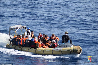 Heart-wrenching photos of migrants being flipped into the sea as their overcrowded boat overturns off the coast of Libya