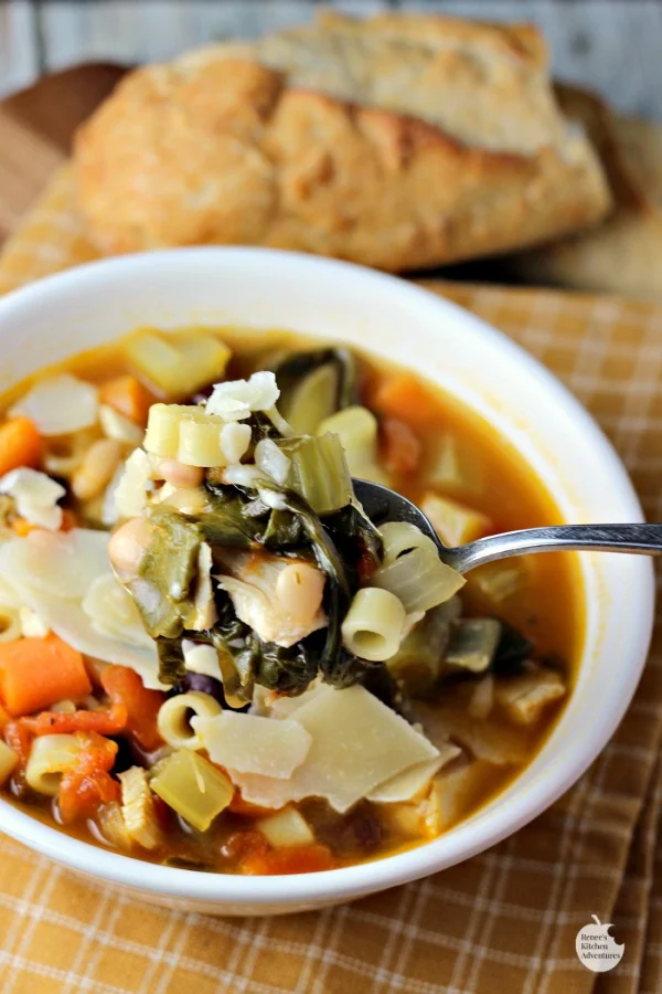 Turkey Minestrone Soup by Renee's Kitchen Adventures on a spoon over a bowl 