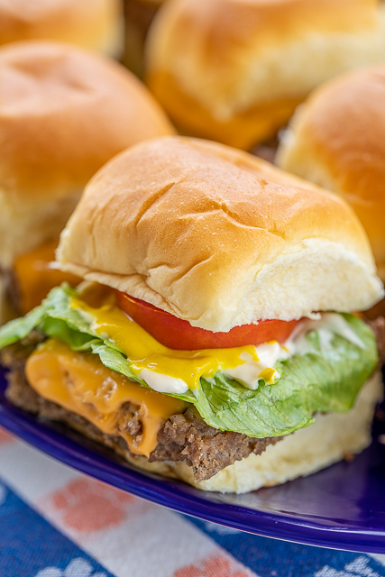 Cheeseburger Sliders - only 5 ingredients!! Ground beef, sausage, ranch dressing mix, cheese and buns. PERFECT for tailgating and parties!! Can make ahead of time and heat in the oven or on top of the grill when ready to serve. Top with your favorite burger toppings - lettuce, tomato, bacon, pickles, mayo, ketchup, mustard. SO easy and SOOOO good!!! Seriously our favorite burger recipe! #tailgating #burgers #beef #partyfood Cheeseburger Sliders - only 5 ingredients!! Ground beef, sausage, ranch dressing mix, cheese and buns. PERFECT for tailgating and parties!! Can make ahead of time and heat in the oven or on top of the grill when ready to serve. Top with your favorite burger toppings - lettuce, tomato, bacon, pickles, mayo, ketchup, mustard. SO easy and SOOOO good!!! Seriously our favorite burger recipe! #tailgating #burgers #beef #partyfood