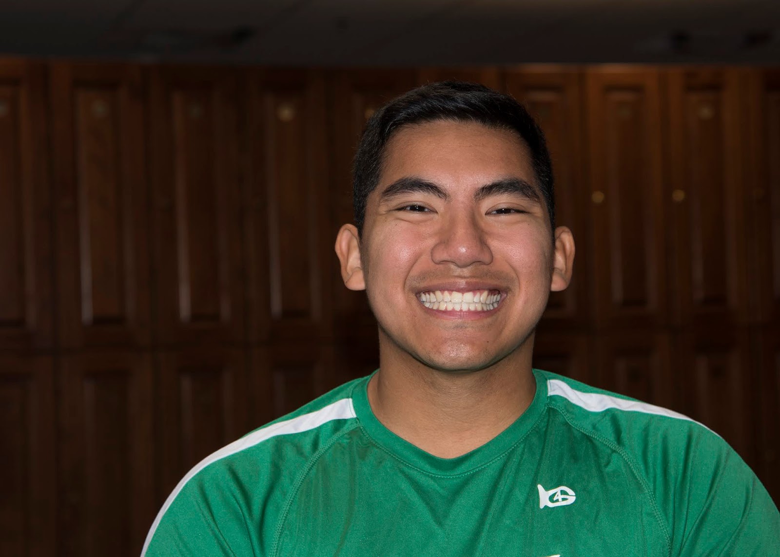A man poses for a photo in the student lounge.