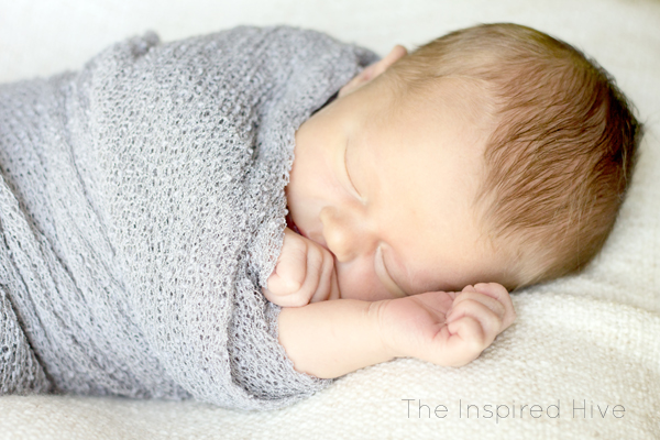 Our natural birth story- a quick labor with a surprising ending. Grey newborn wrap photography.