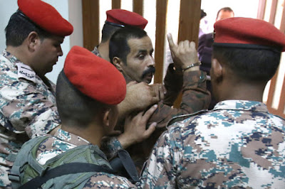 First Sgt. Ma’arik al-Tawayha being led out of court. Credit: Khalil Mazraawi / AFP - Getty Images photo