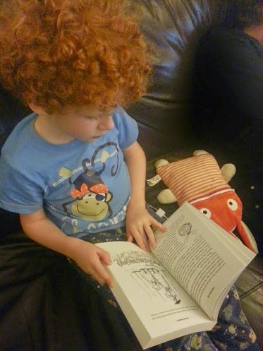 6 year old boy reading Arvor's Schooldays book