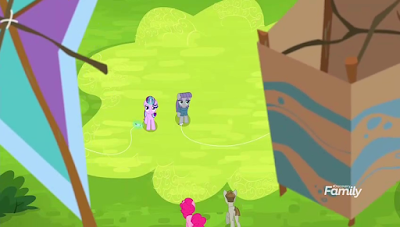 Distant shot of Starlight and Maud on the ground, with their kites either side in the foreground. Pinkie and Mudbriar are approaching