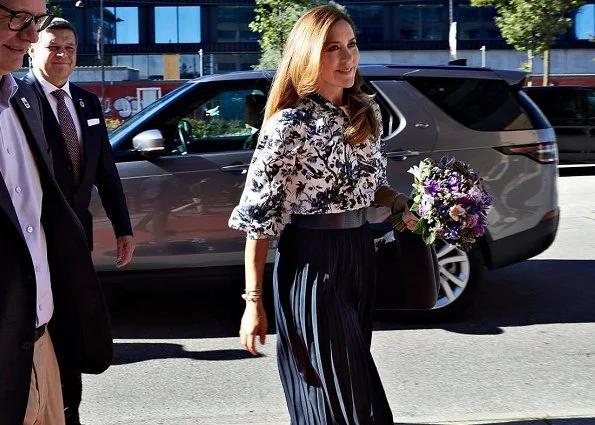 Crown Princess Mary wore a new Arlette printed crepe de chine blouse from Erdem. Gianvito Rossi purple pumps, pleated midi skirt