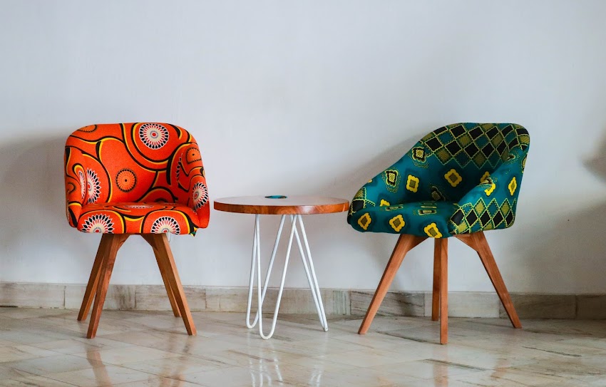 Two Assorted-color Padded Chairs Near Side Table Two Assorted-color Padded Chairs Near Side Table