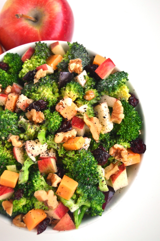 Healthy Broccoli Salad is made lighter with a creamy Greek yogurt dressing, Braeburn apples, cheddar cheese, grapes, walnuts and dried cranberries. www.nutritionistreviews.com