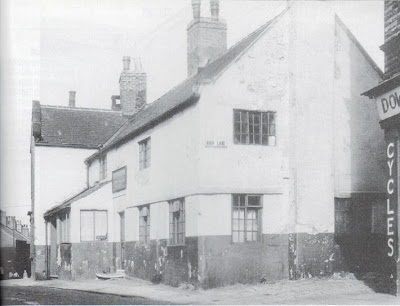 A black and white picture of a delapidated pub