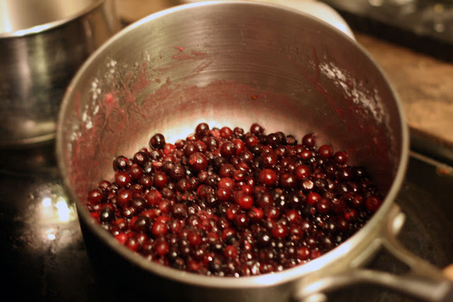 A small pot of saskatoon berries glazed in sugar, water, and lemon juice.