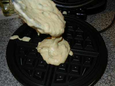 putting batter into a waffle iron 