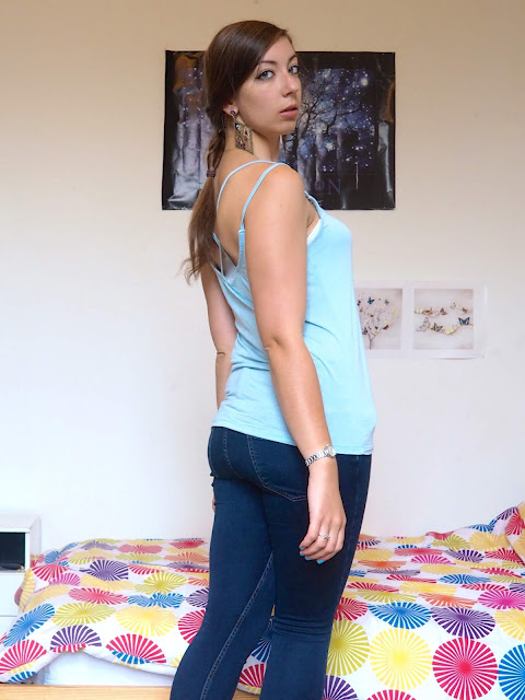Princess Jasmine Disneybound outfit of light blue vest top with strap details & dark blue skinny jeans