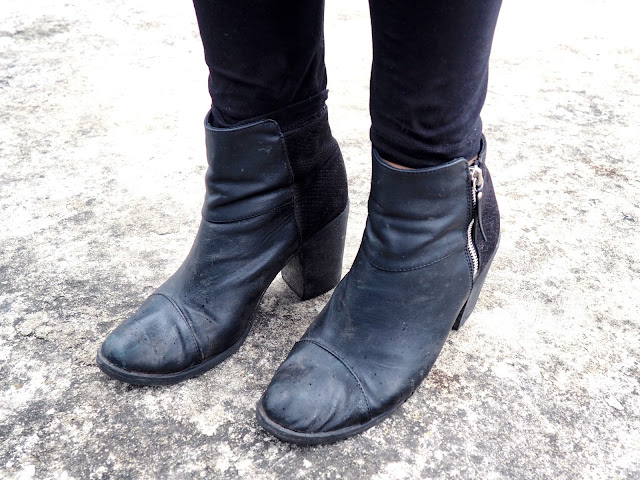 Sparkle | outfit details of heeled black ankle boots with zipper detail