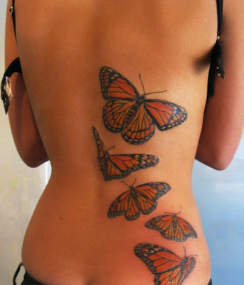 Tatuaje mariposas volando en la espalda