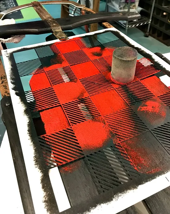 Stenciling red on a stencil on the sled