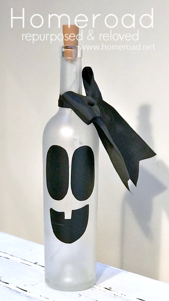 Frosted white wine bottle with ghost face and black bow