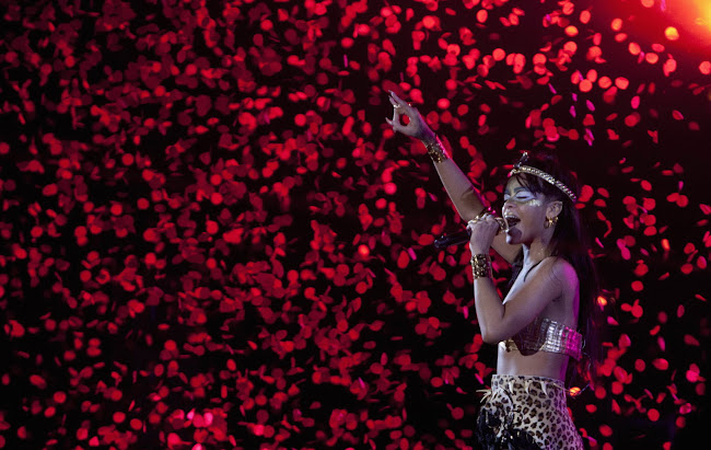 amazing photo with Rihanna Performing at the Robin Hood Foundation Benefit 2012 with millions of red flowers flying in the background