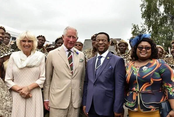 Prince Charles and Duchess of Cornwall met with King Goodwill and Queen Pumi of the Zulus. Burberry trench coat