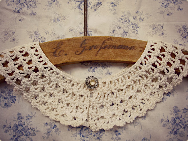 vintage crochet collar displayed on wood hanger