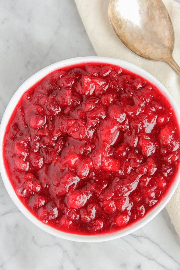 This beautiful, bright red Cranberry-Apple Sauce will soon become a staple on your holiday dinner table! Simple and easy to make, it's both tart and sweet, and full of flavor. 
