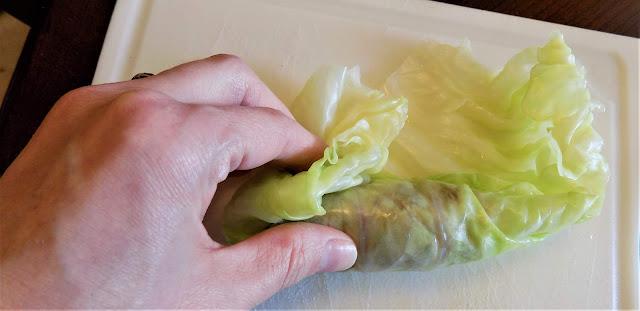 A picture of a cabbage roll being assembled