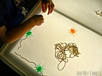Building a giant spiderweb on the light table from And Next Comes L