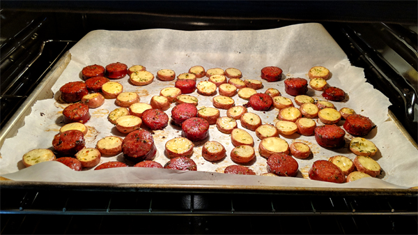 image of sausage and potatoes cooking in the oven